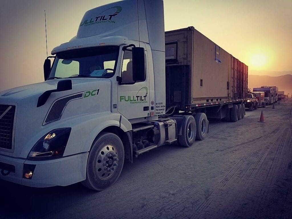 A Full Tilt Flatbed is delivering a load at Burning Man