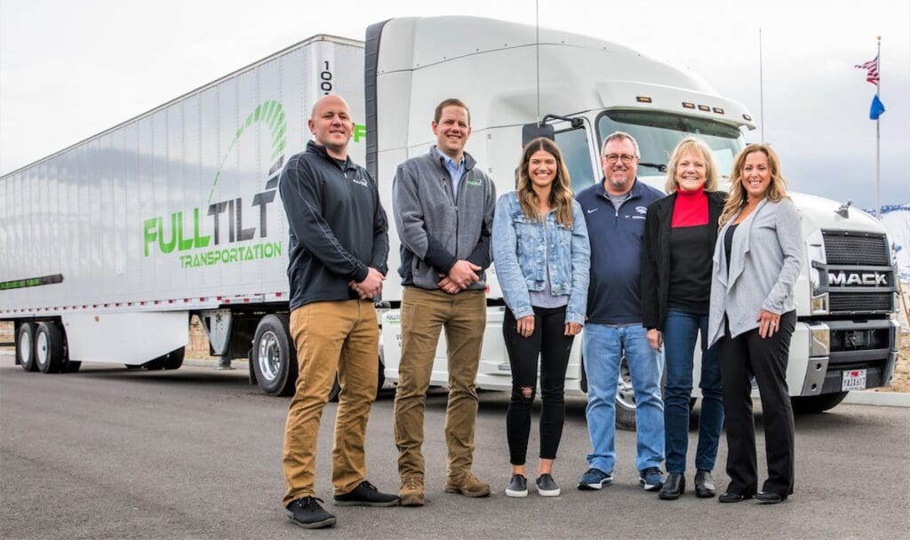 left to right: Nic Novich, Cris Novich, Jessica Novich, Robert Novich, Cindy Novich and Jessica Novich are standing in front of a Full Tilt Truck and Trailer