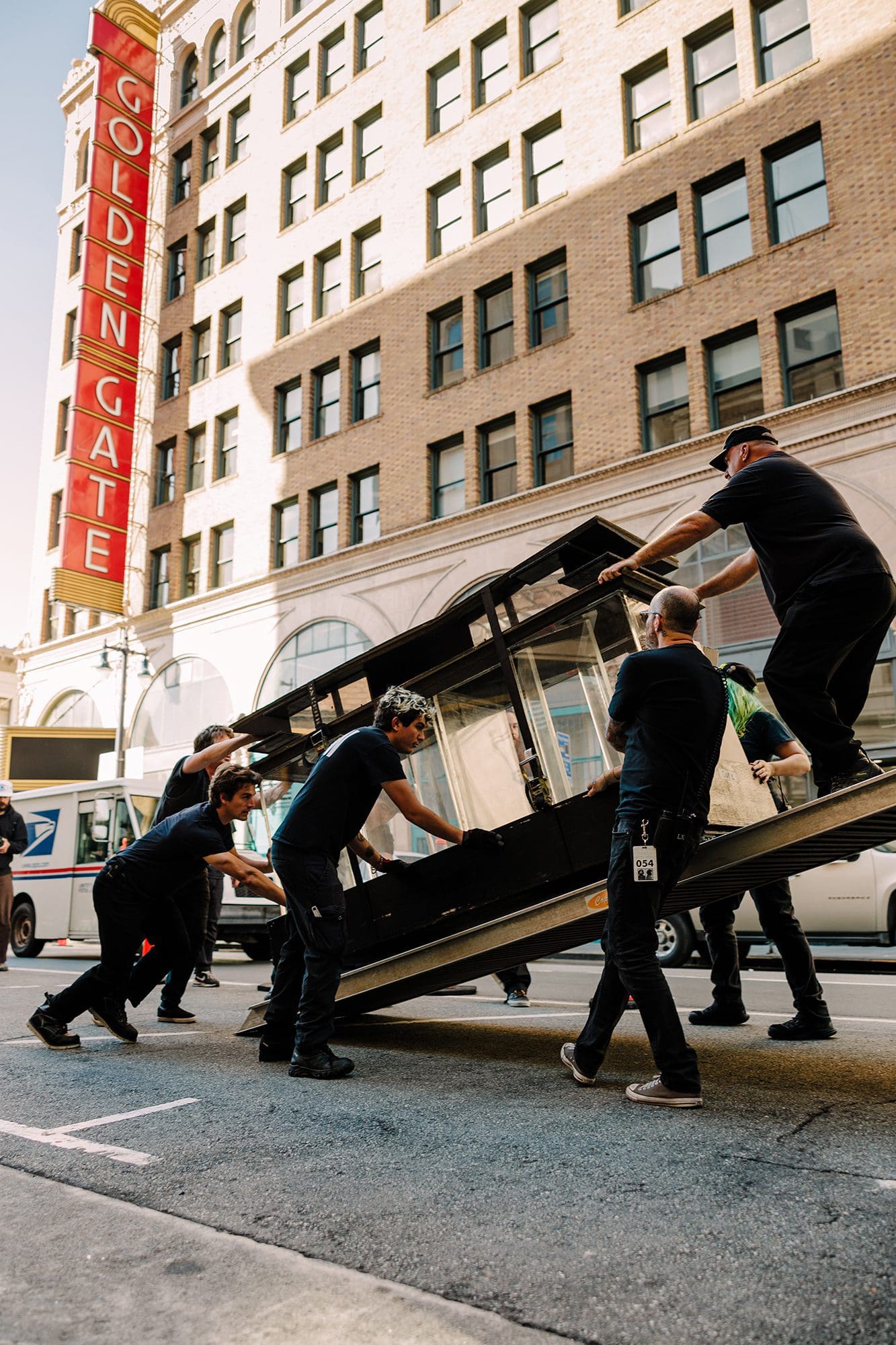 Crew loading and unloading tour equipment, including LED panels and road cases, demonstrating efficient work by a tour logistics company.