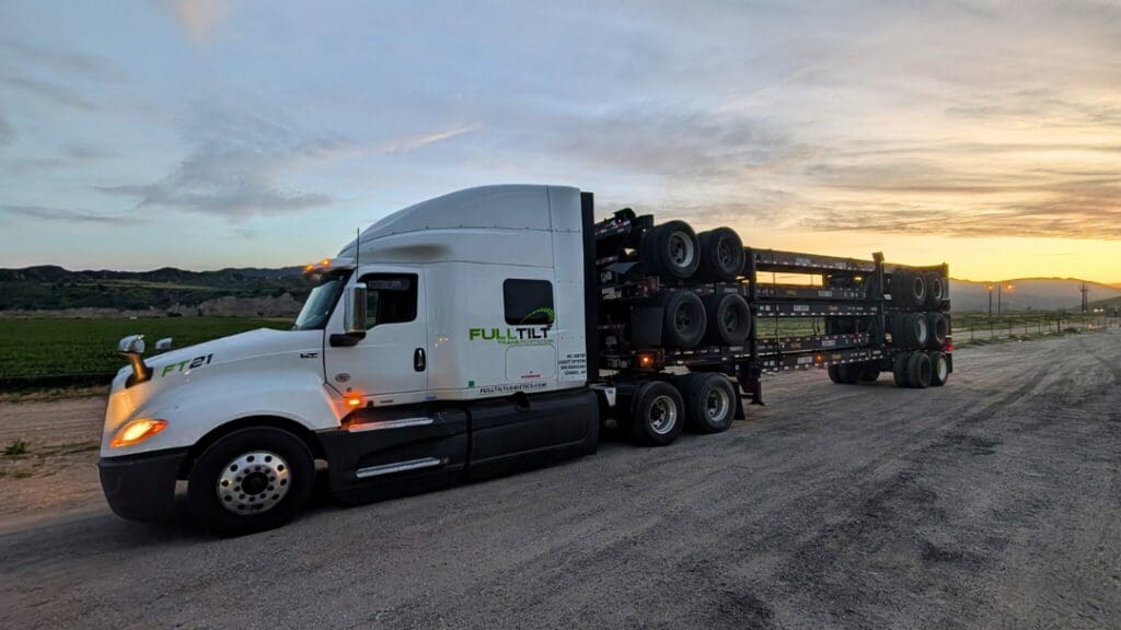 A Full Tilt truck is carrying multiple chassis on a flatbed in Northern Nevada
