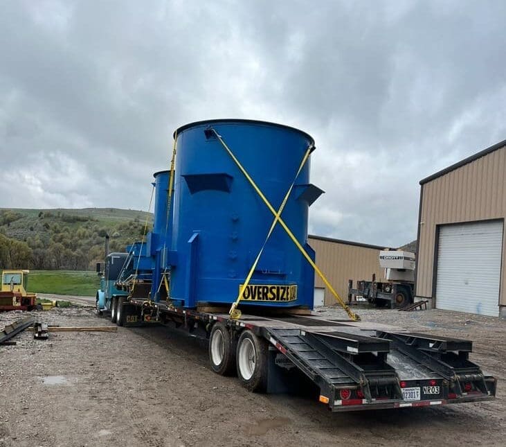 A truck is hauling an oversize load to a laydown yard